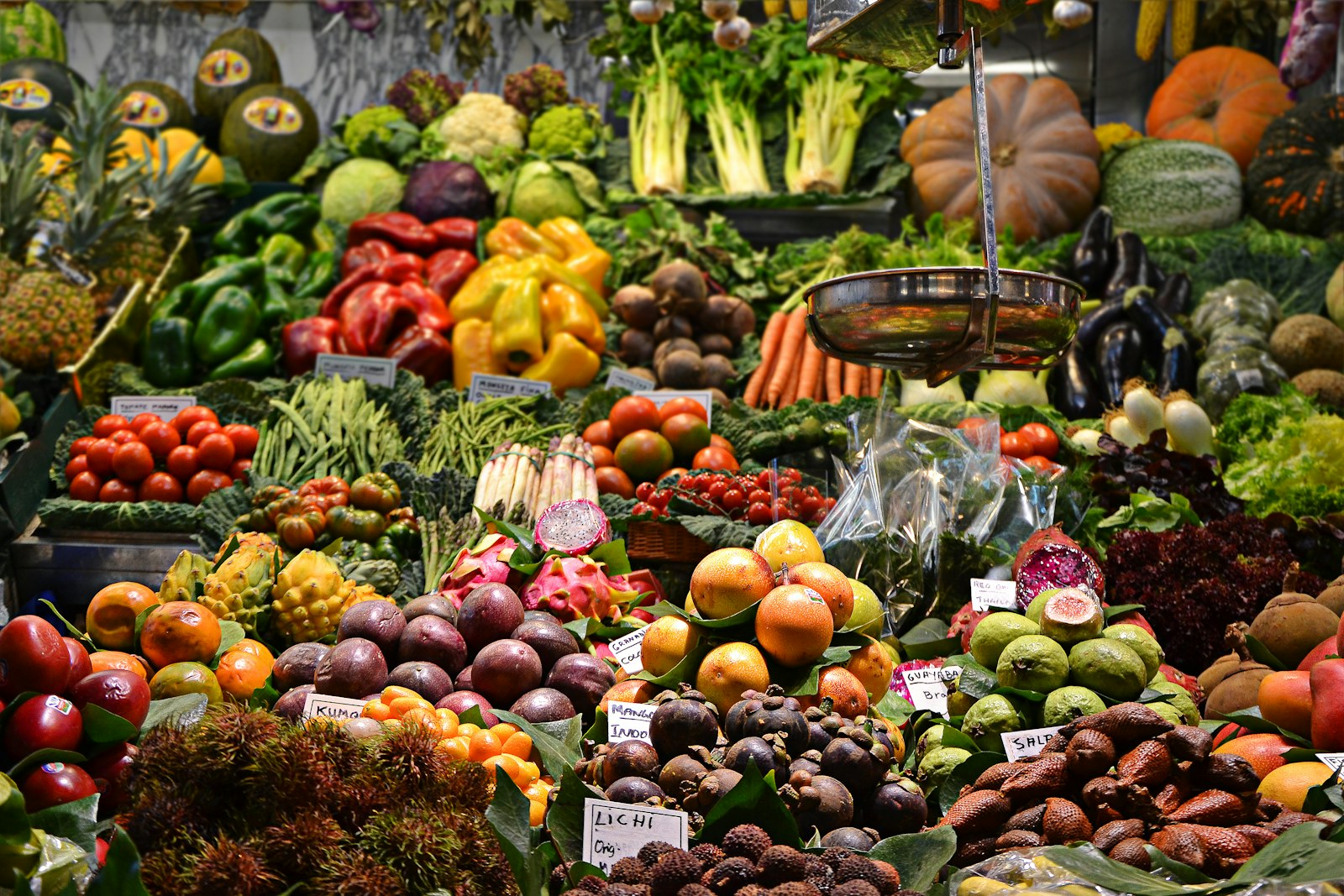 A crowded market stall stacked with produce